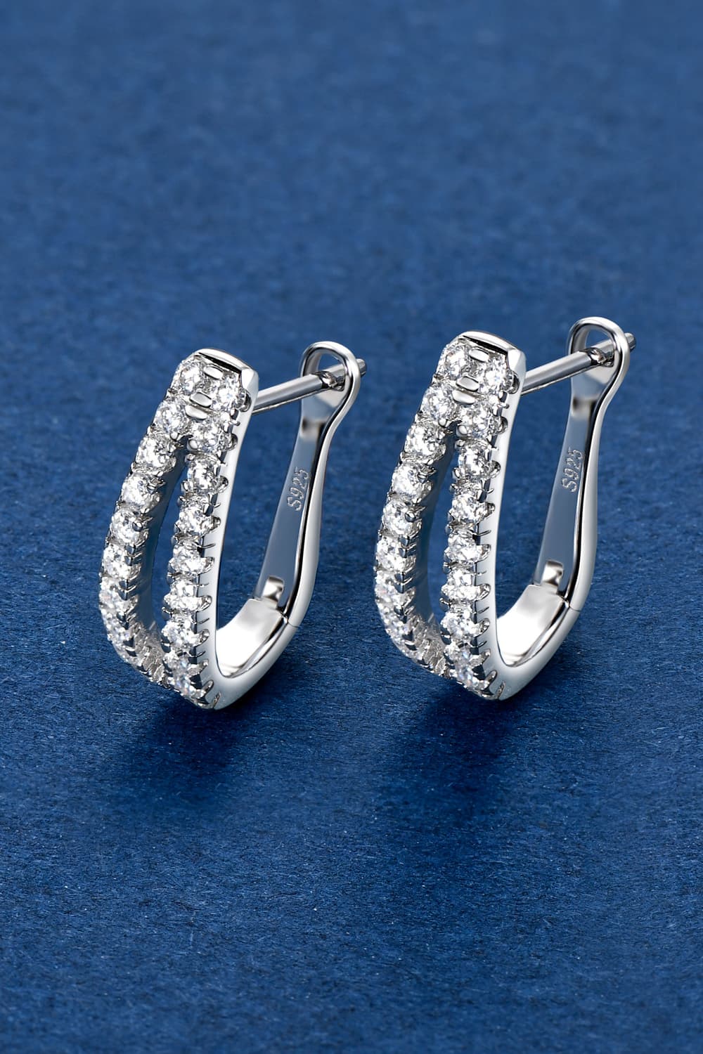 Pavé hoop sterling silver earrings with sparkling cubic zirconia stones.