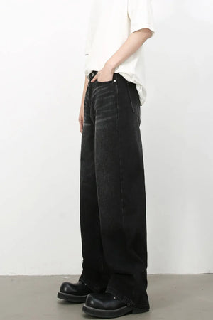 Wide leg distressed denim trousers in dark wash with a casual fit.