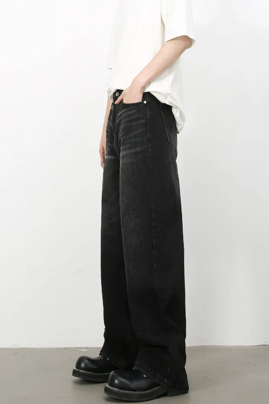 Wide leg distressed denim trousers in dark wash with a casual fit.
