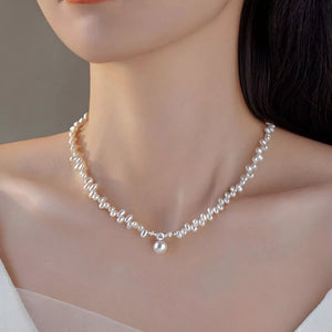 Lustrous irregular pearl pendant necklace with a single pearl drop and crystal accent.