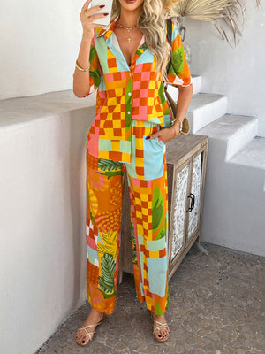 Women's abstract print resort co-ord set with wide leg pants and a collared button-up shirt in multicolor.