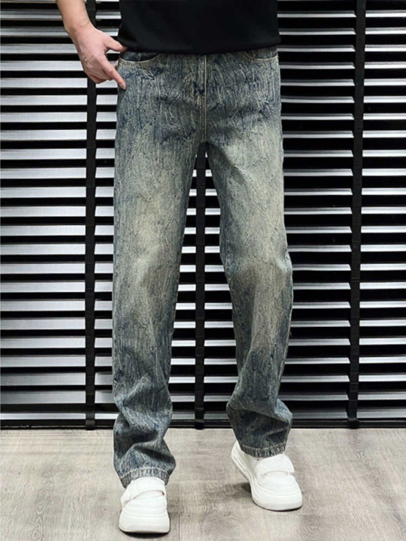 Men's relaxed fit jeans in vintage wash blue cotton with distressed detailing.