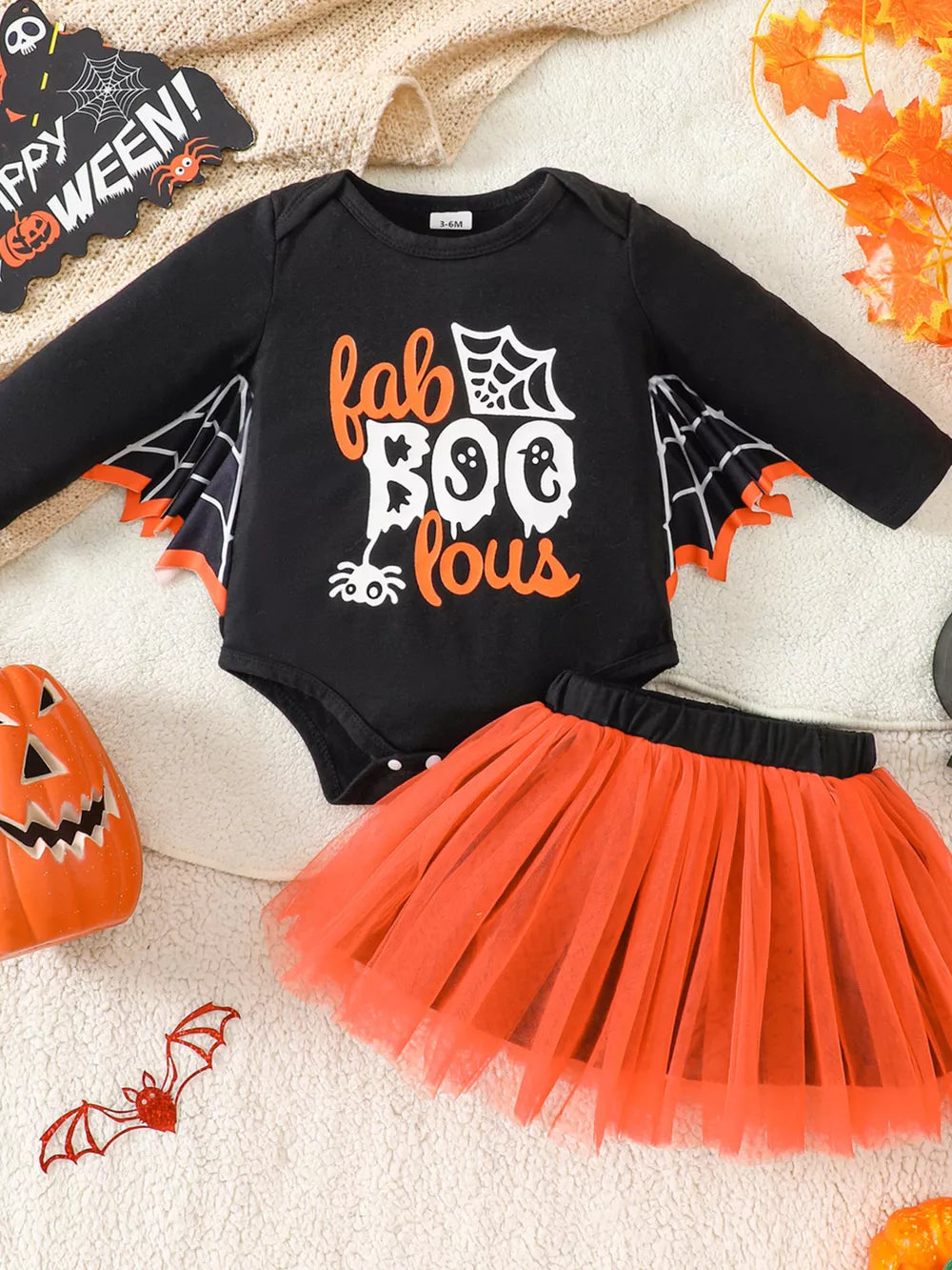 orange outfit set featuring layered and graphic print