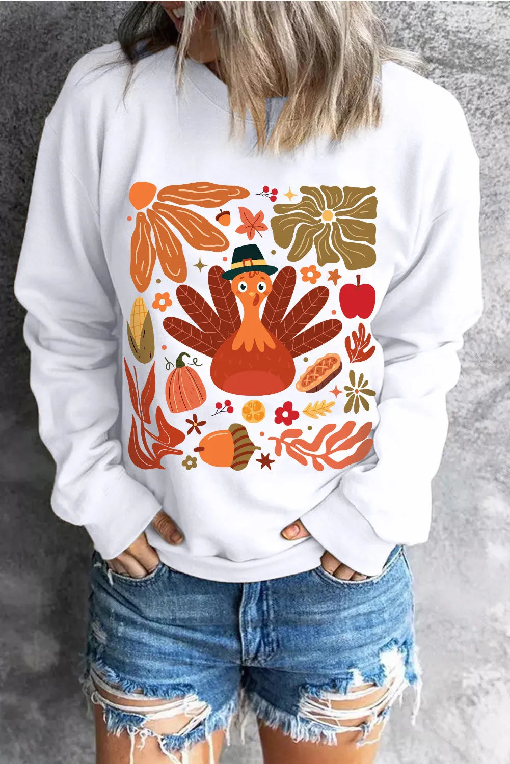 White round neck sweater with a playful Thanksgiving turkey and fall graphic print.
