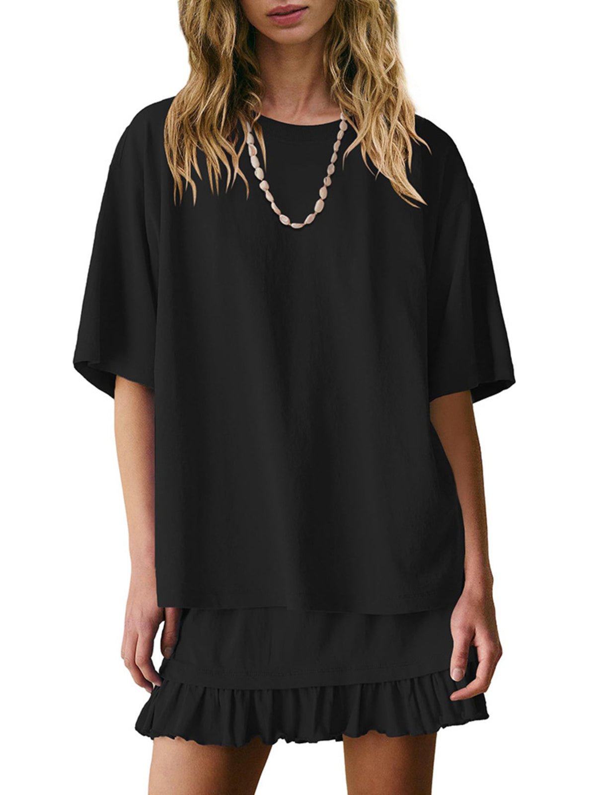 Black relaxed fit tee and ruffled skirt set with crew neck and short sleeves.