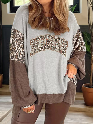 Leopard print graphic sweatshirt with colorblock sleeves and hem, featuring "MERRY" text.