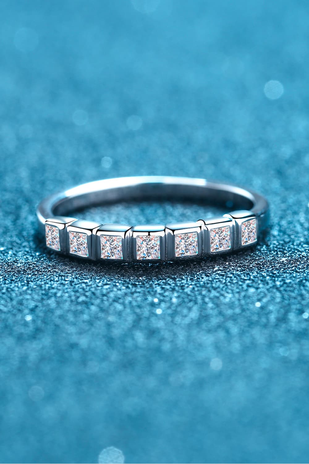Silver band ring with princess cut diamonds in square settings