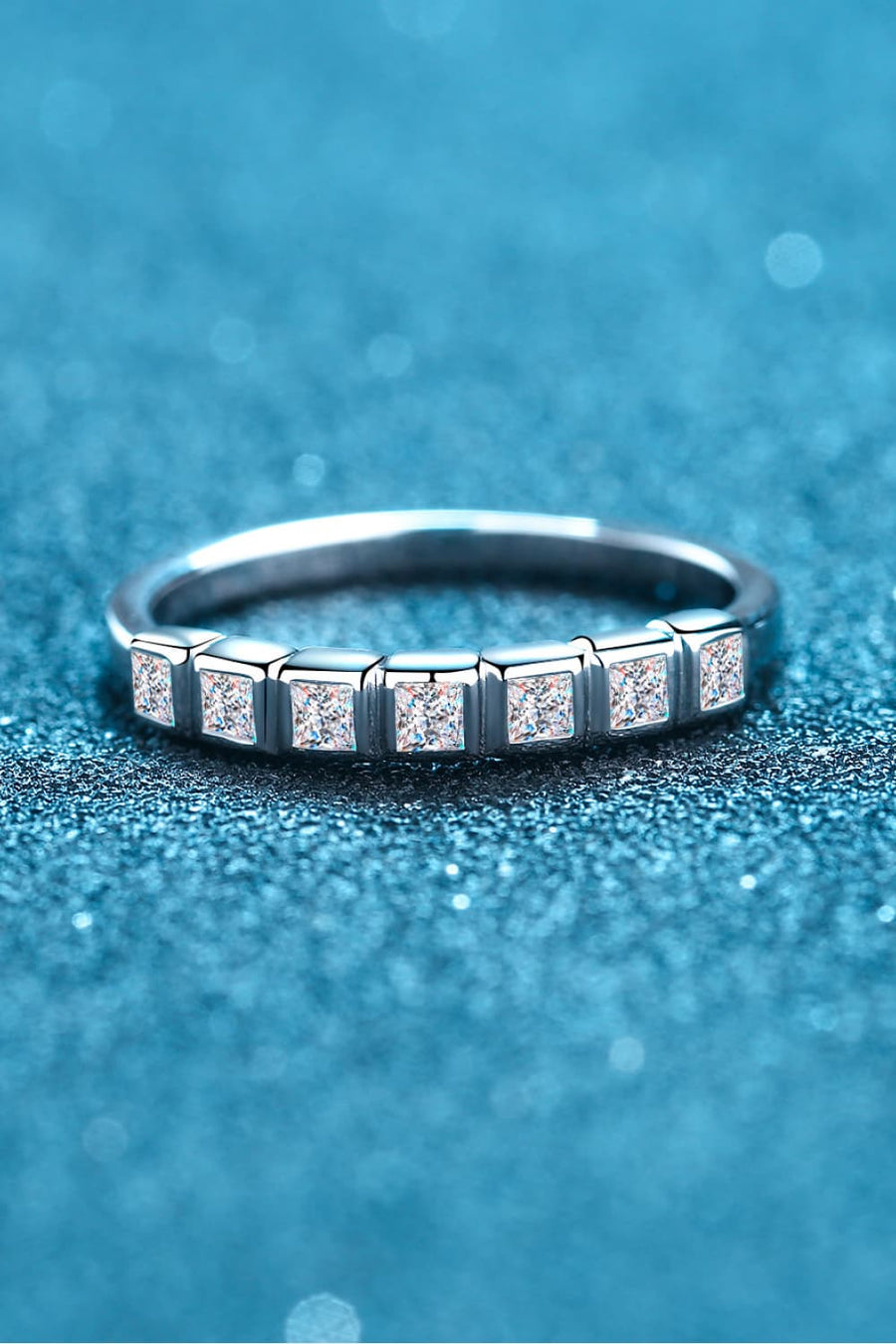 Silver band ring with princess cut diamonds in square settings