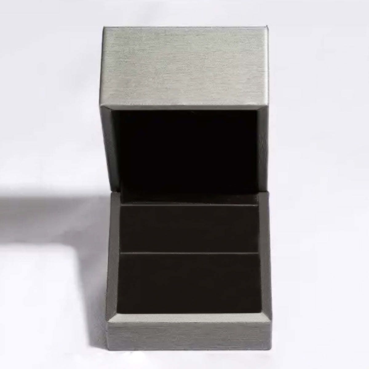 Open ring box with grey exterior and black interior.