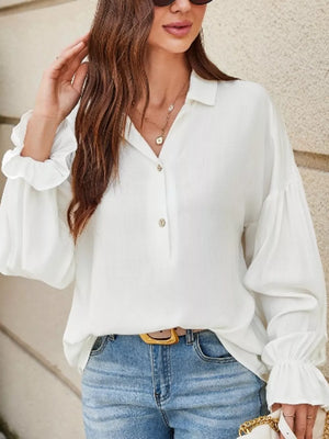 White linen blend shirt with billowy sleeves and ruffled cuffs, collared neckline.