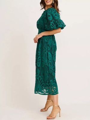 Green lace midi dress with puff sleeves and a cinched waist.