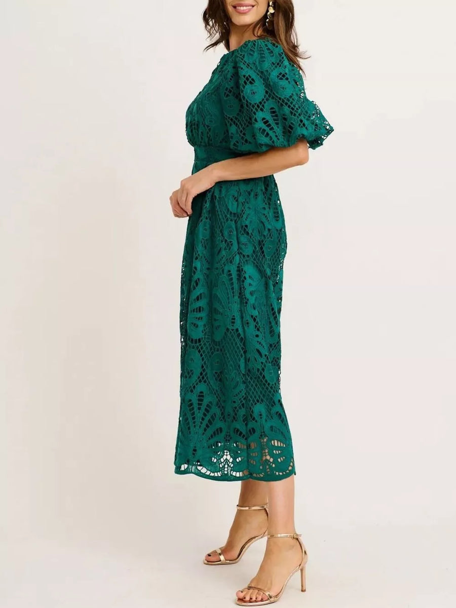 Green lace midi dress with puff sleeves and a cinched waist.