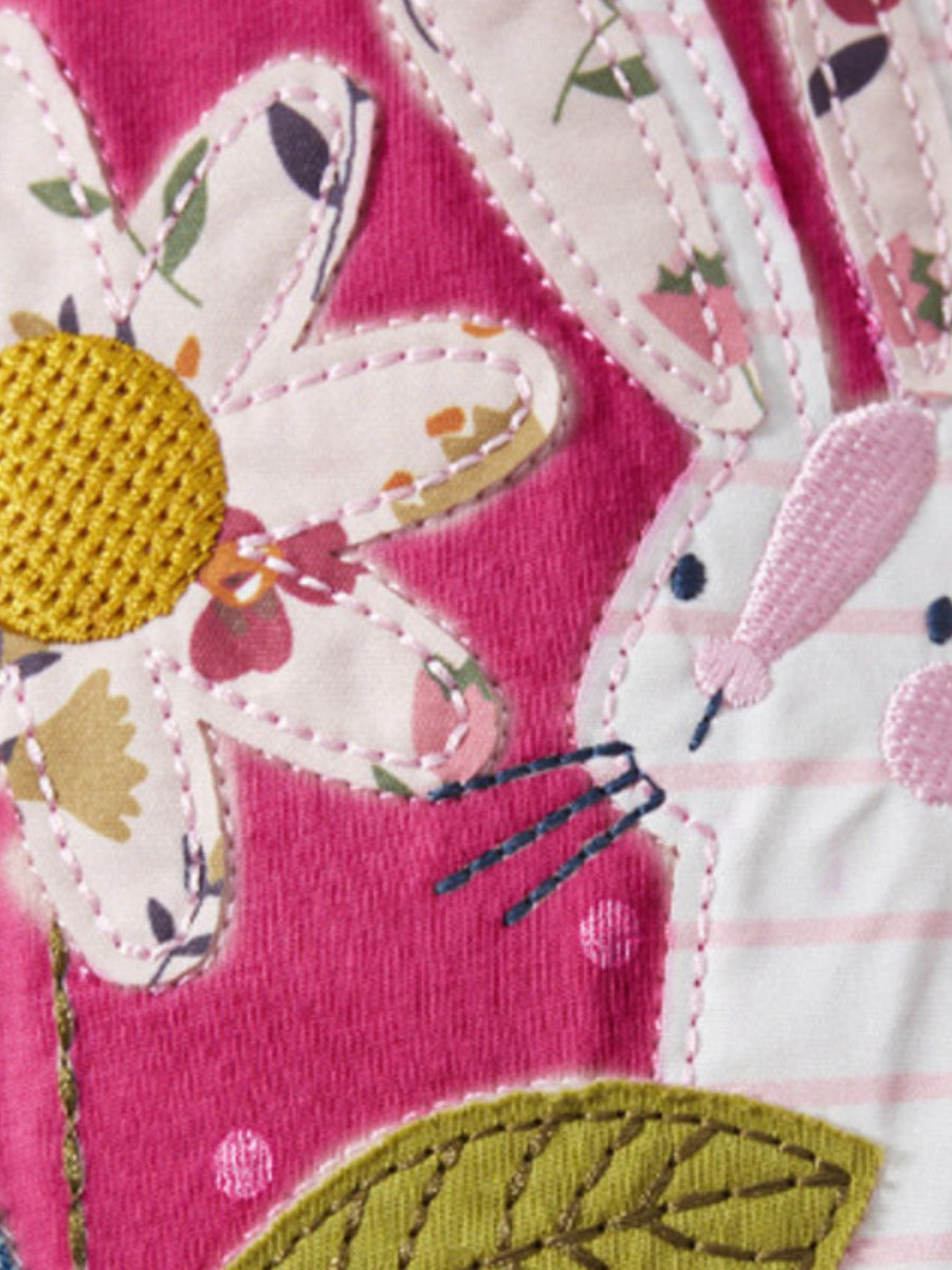 Embroidered animal play dress in pink cotton with appliquéd bunny and floral details.
