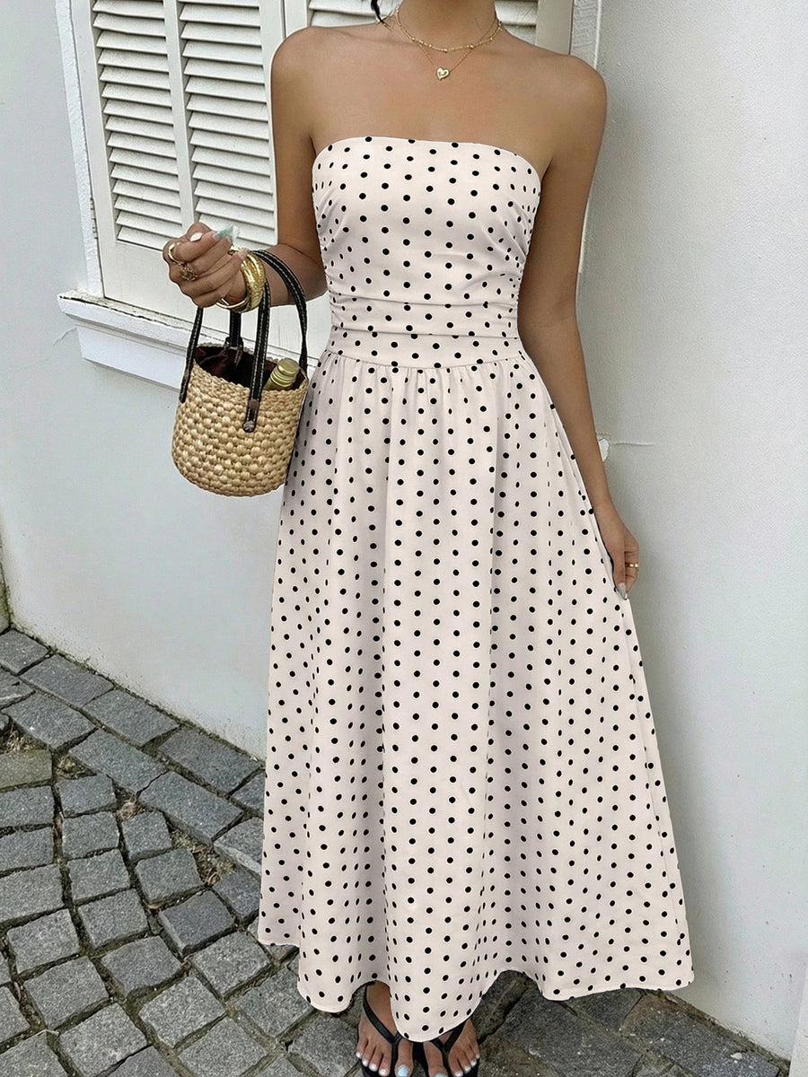 Chic white polka dot A-line maxi dress with a strapless neckline and cinched waist.