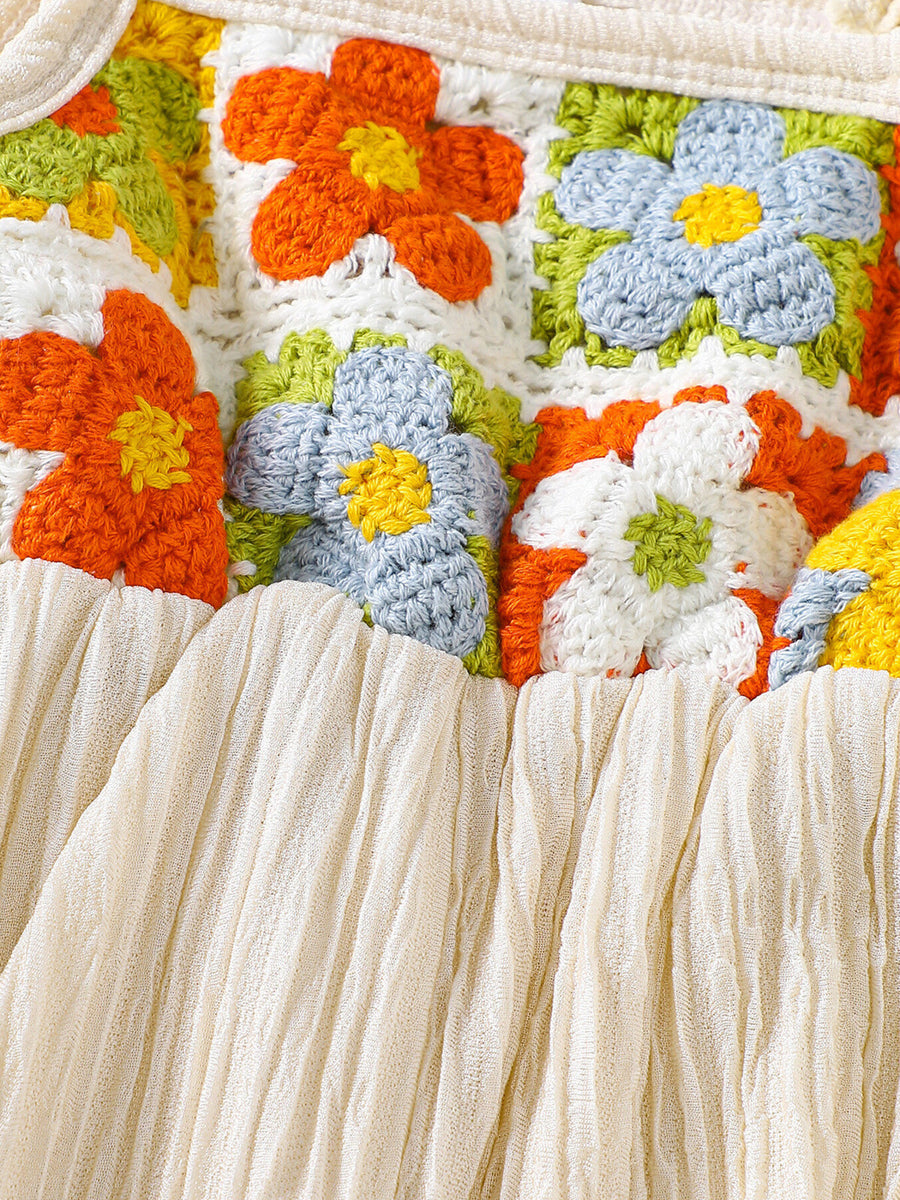 Crochet baby jumpsuit with colorful floral squares and cream ruffled trim