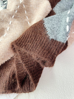 v-neck sweater featuring argyle in beige with 100% polyester Care instructions: Machine wash cold texture