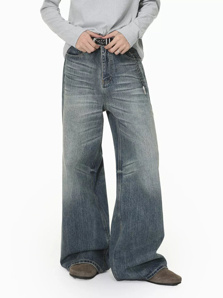 Men's wide leg denim jeans in faded blue wash with a relaxed fit.