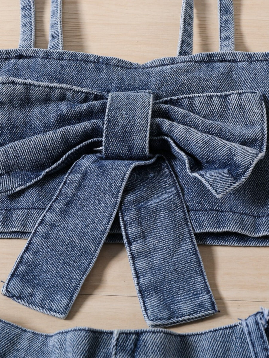 Toddler denim bowknot top with straps and matching skirt detail.