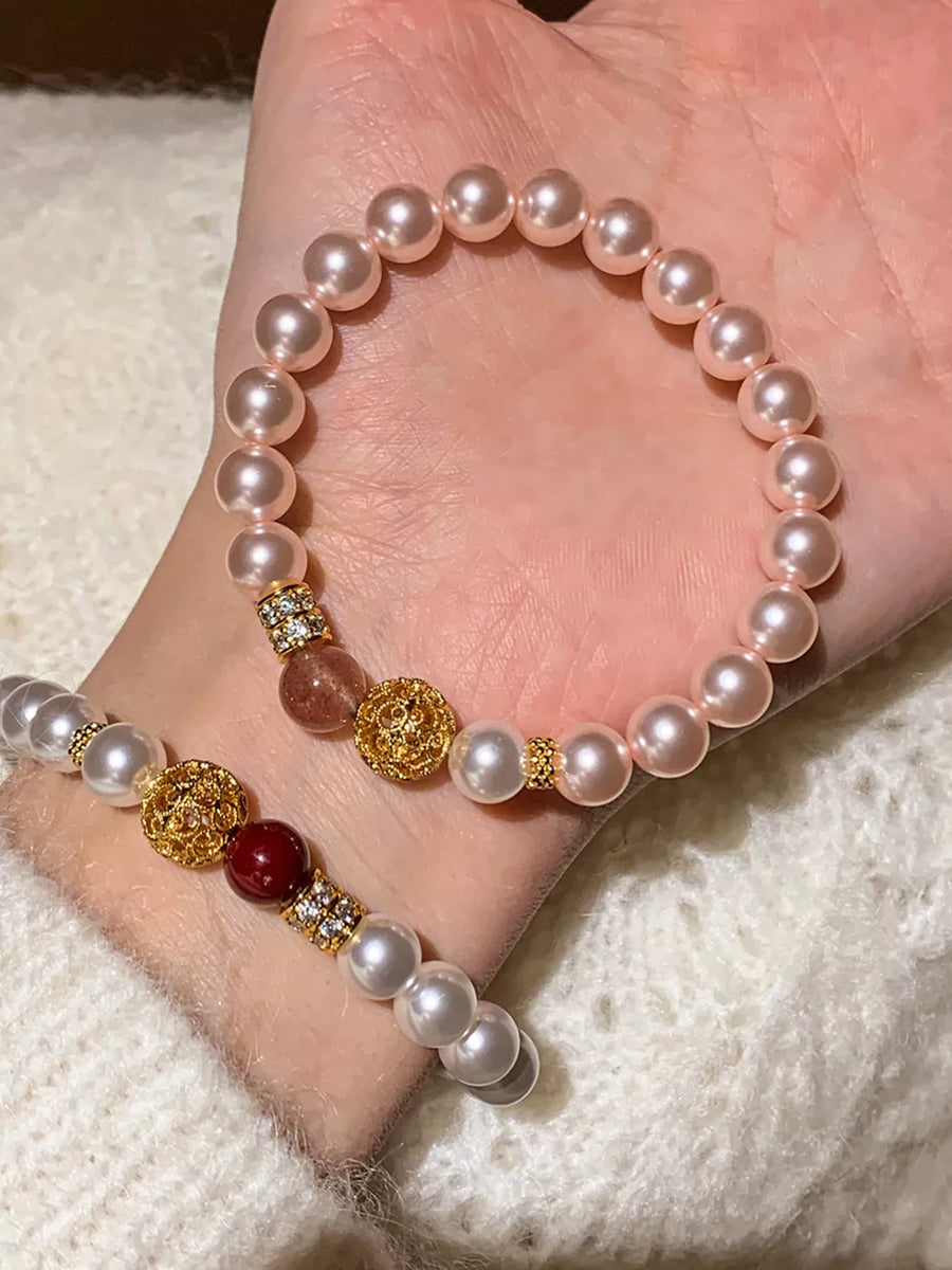 Elegant pearl beaded bracelets with gold accents and crystals, in white and blush pink.