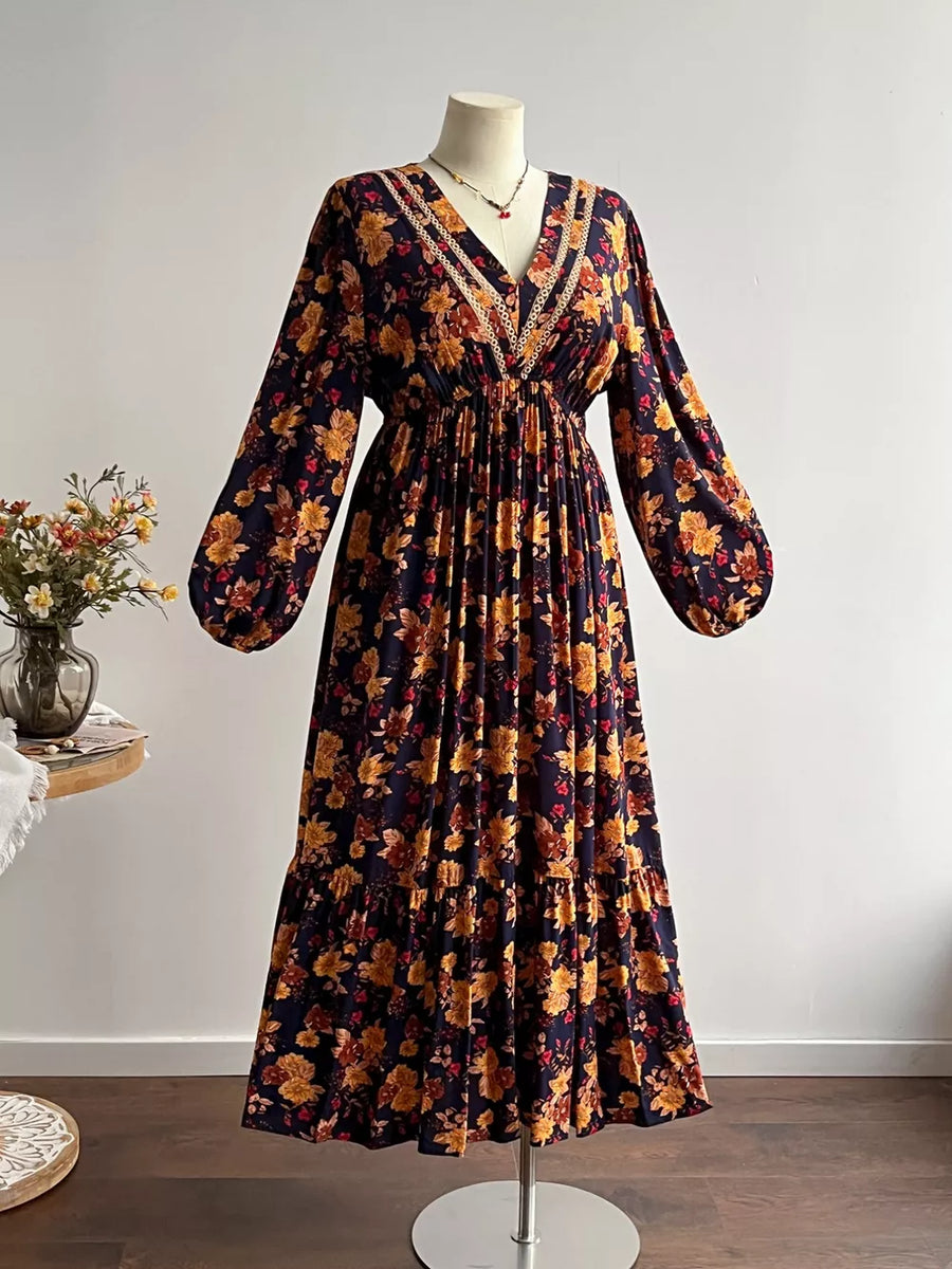 Floral V-neck maxi dress with long sleeves, tiered skirt, and lace trim.