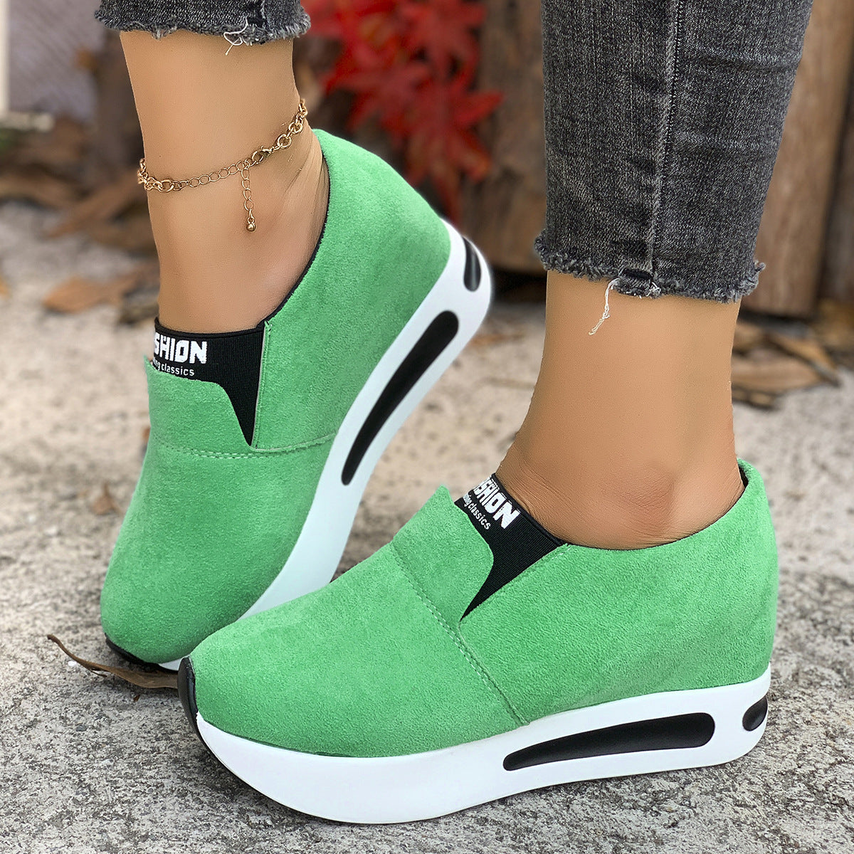 Green round toe platform slip-on sneakers with white soles and black accents.