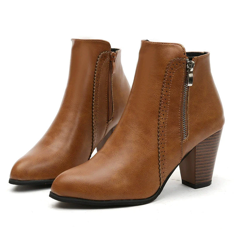 Caramel leather block heel booties with laser-cut detail and side zipper.
