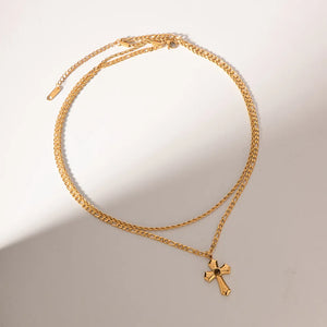 Gold layered chain necklace with sculpted cross pendant
