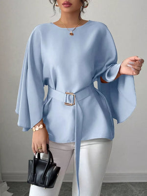 Light blue belted blouse with batwing sleeves and gold buckle detail