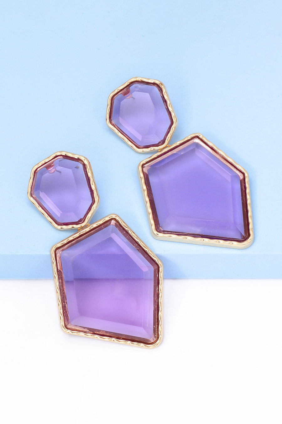Resin facet drop earrings with gold trim in purple, featuring irregular geometric shapes.