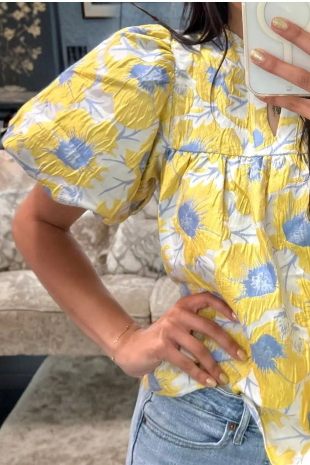 Yellow floral textured blouse with bubble sleeves and a V-neck detail.