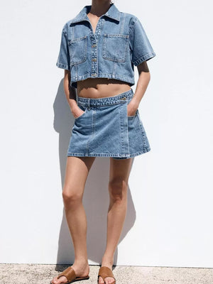 Denim cropped button-up top and skort set with contrast stitching.