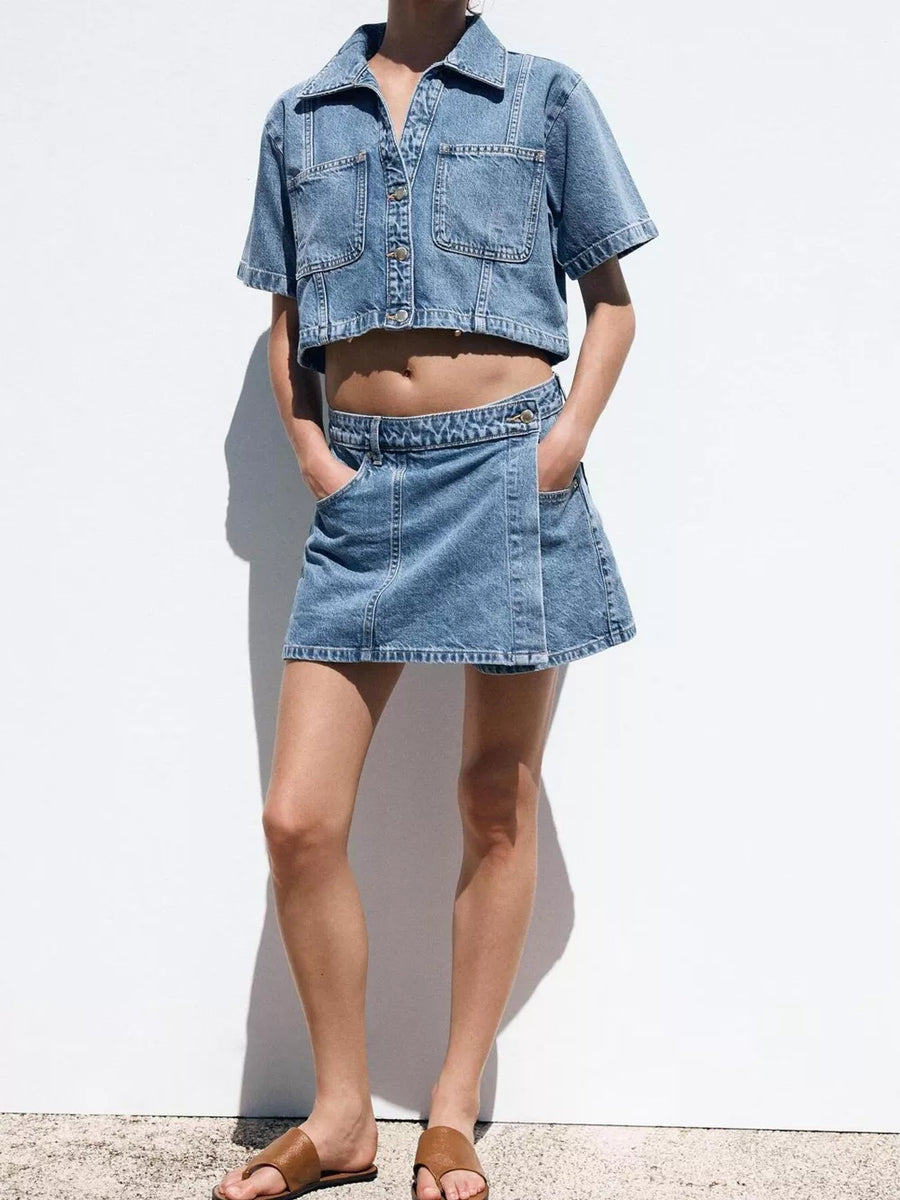 Denim cropped button-up top and skort set with contrast stitching.