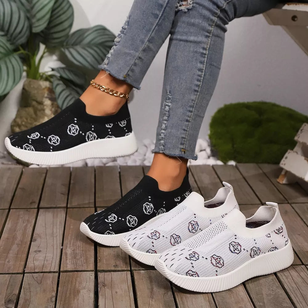 Breathable mesh slip-on sneakers in black and white with all-over pattern.