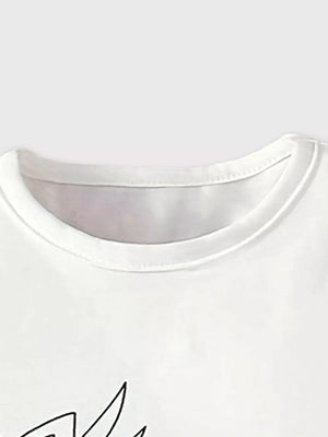 White cotton tee with playful giraffe graphic and floral accents.