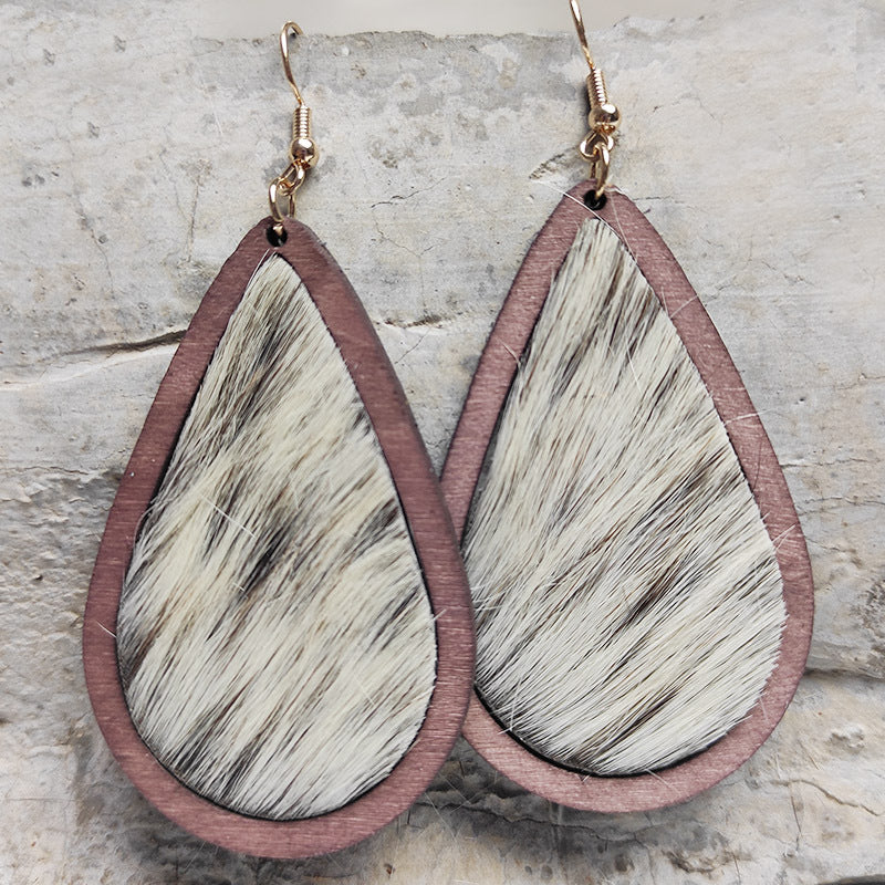Teardrop wood earrings with cowhide inlay and rose gold hooks.