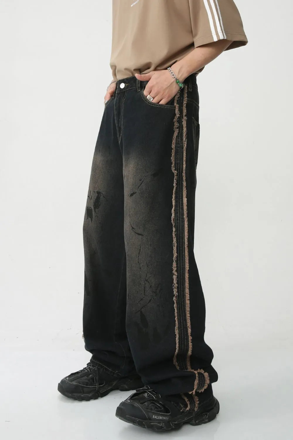 Distressed wide-leg jeans in mocha with frayed trim detail and a relaxed fit.