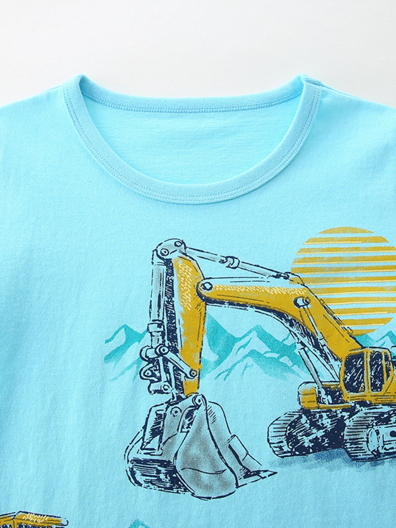 Light blue toddler t-shirt with excavator graphic and mountain scene.