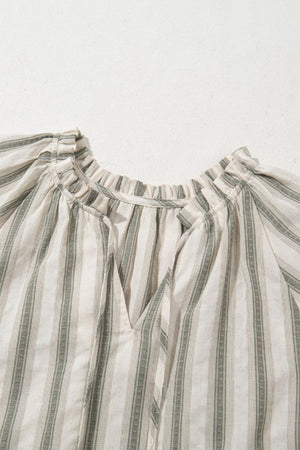 Striped linen blouse with gathered neckline and tie detail.