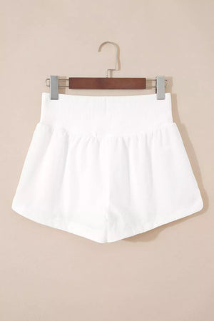 White ribbed-waist high rise relaxed shorts with a-line cut.