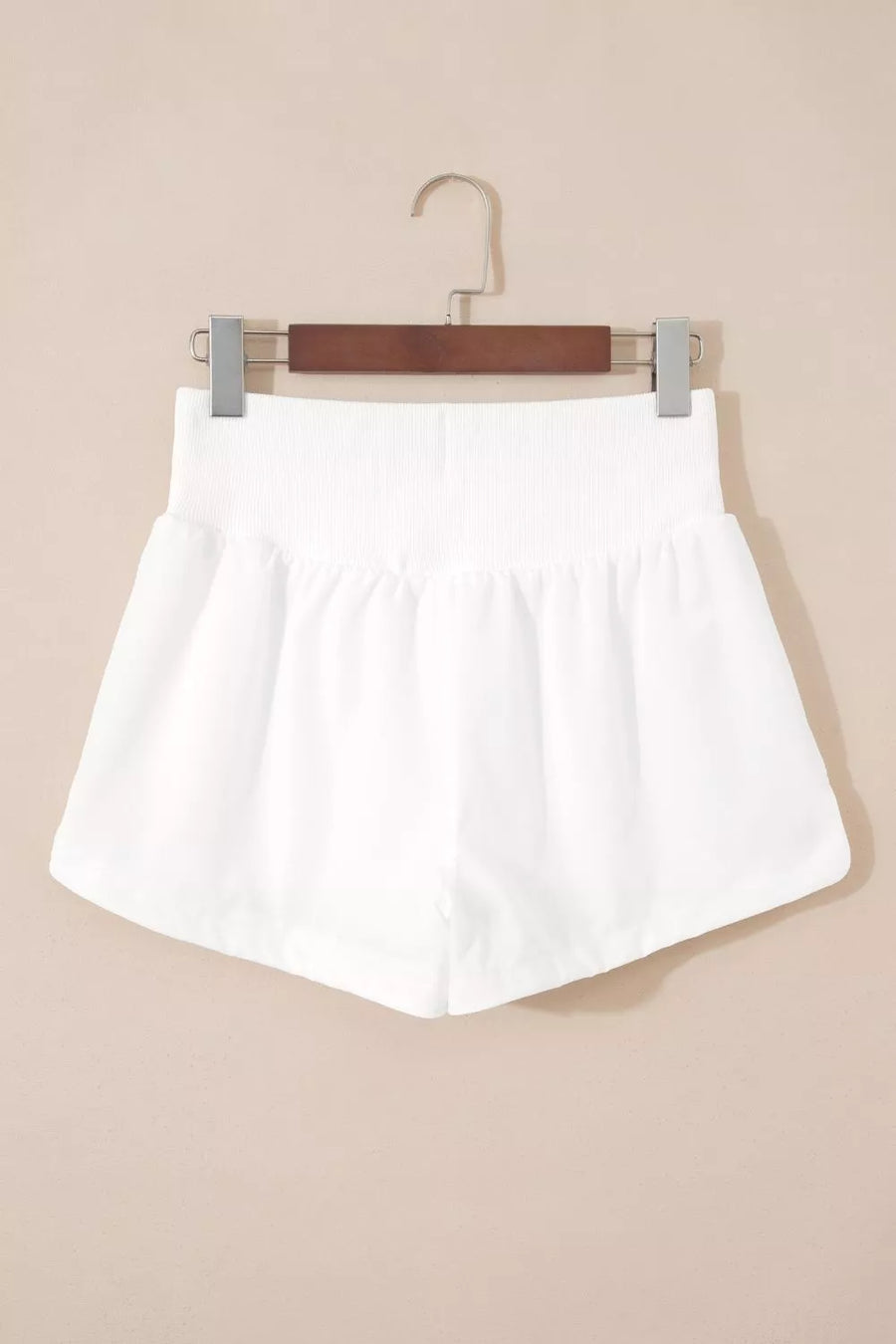 White ribbed-waist high rise relaxed shorts with a-line cut.