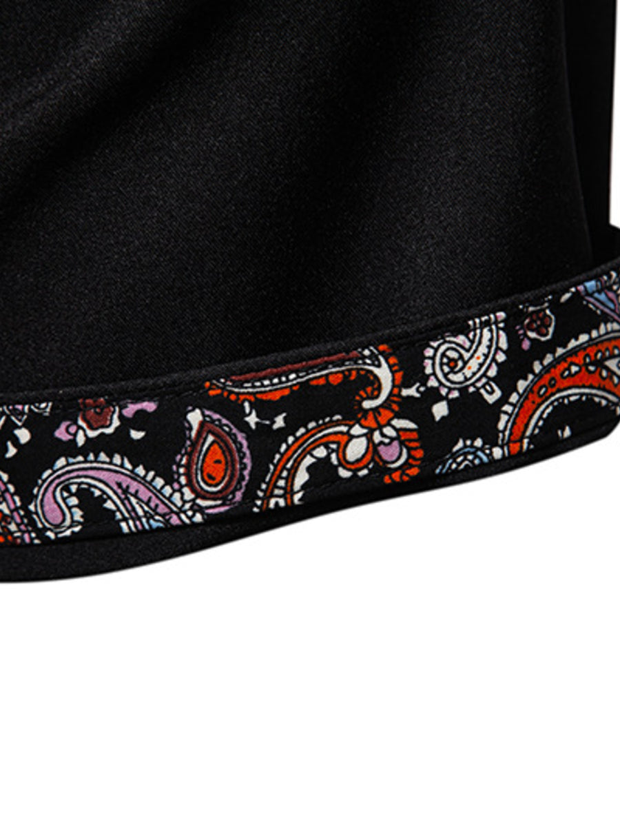 Black cotton blend shirt with colorful paisley trim detail on the hem.