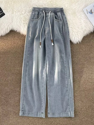 Men's light blue wide-leg jeans with drawstring waist and distressed details.