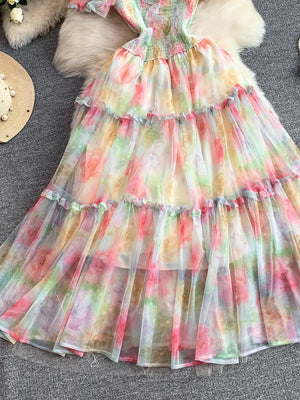 Floral tiered midi dress with smocked bodice in a multicolor pastel tie-dye print.