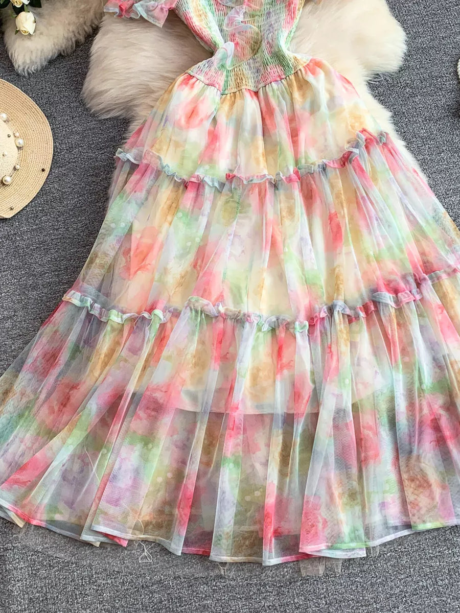 Floral tiered midi dress with smocked bodice in a multicolor pastel tie-dye print.