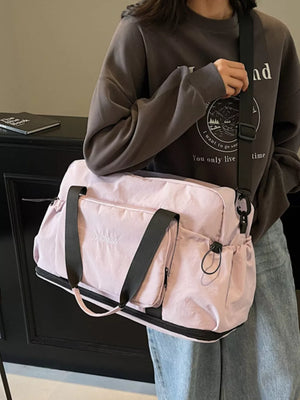 Light purple duffle bag with black straps and multiple pockets, perfect for gym or travel.