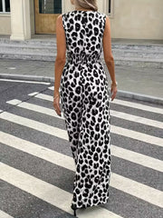 Sleeveless leopard print romper with smocked waist and wide legs.