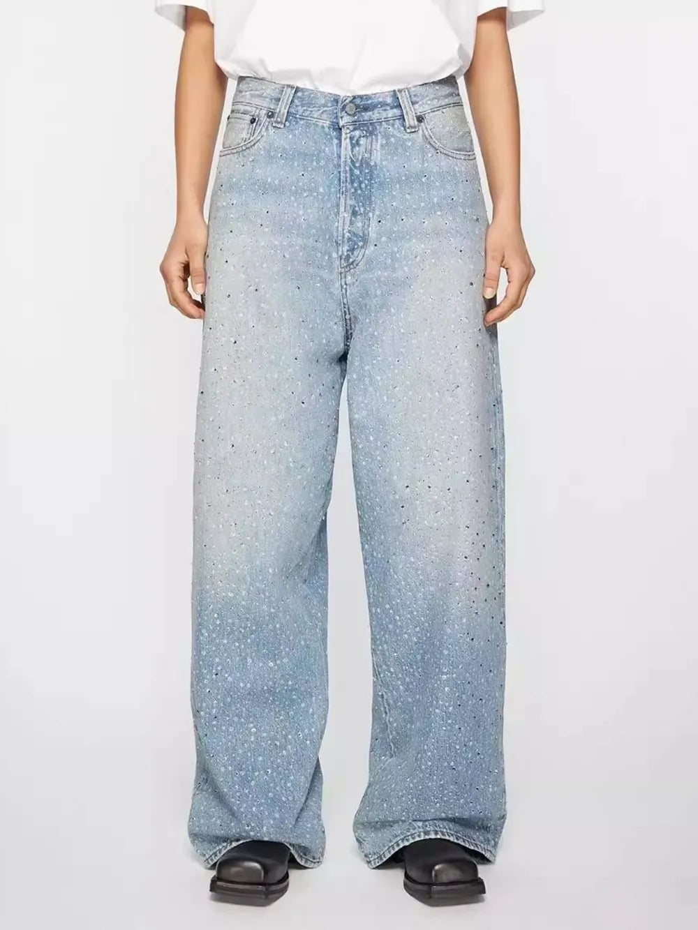 Embellished wide-leg denim trousers in medium wash with scattered rhinestones.