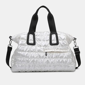 White glossy padded weekend holdall bag with black straps and a front zip pocket.