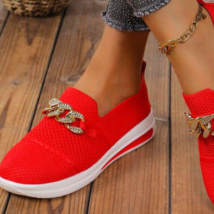 Red mesh slip-on flats with chunky gold chain detail and white sole.