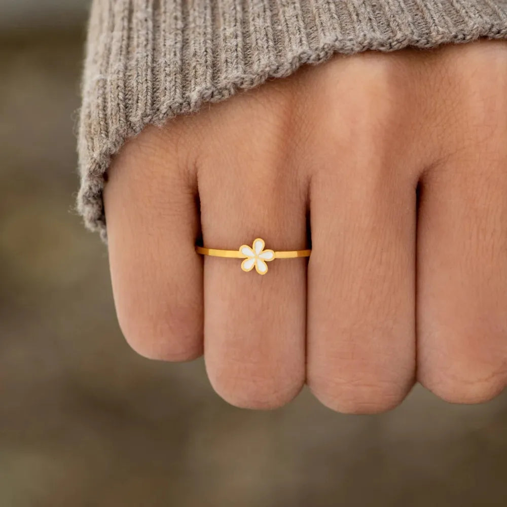 Delicate gold ring with white floral enamel detail